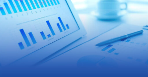 charts and graphs displayed on laptop and hard copies