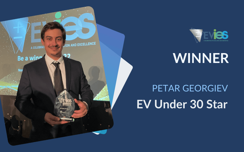 Peter Georgiev holding his Evies 2021 EV Star under 30 glass trophy